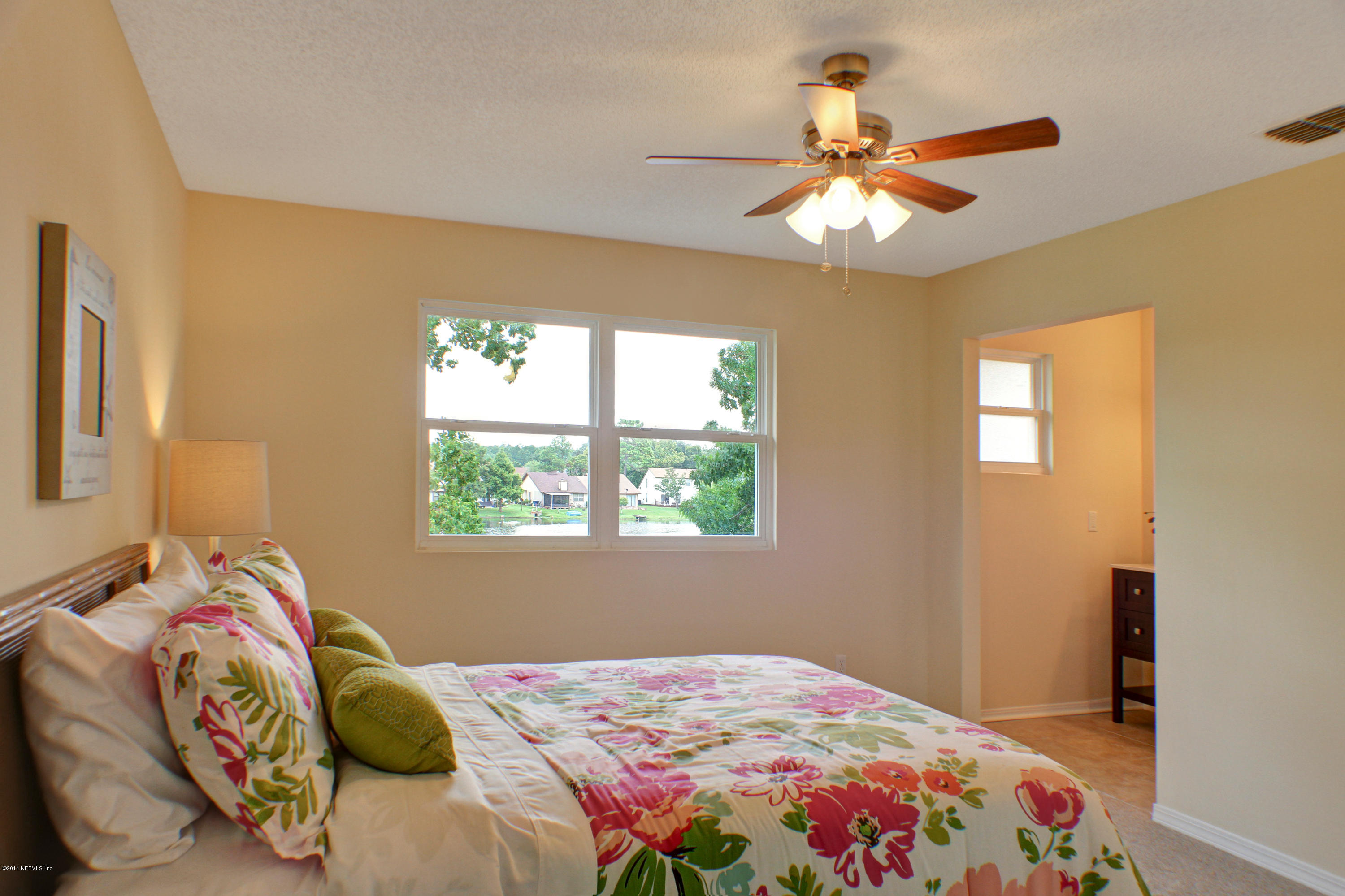 1723 Derringer Road Jacksonville, FL 32225 - Photo 16 of 22 a bedroom with a bed and a window