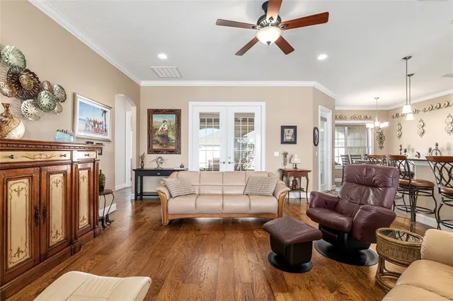 a view of a hallway with wooden floor and a bathroom