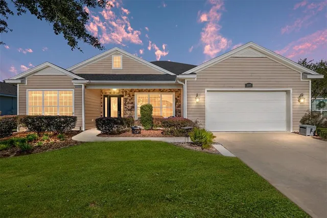 a front view of a house with a yard and outdoor seating
