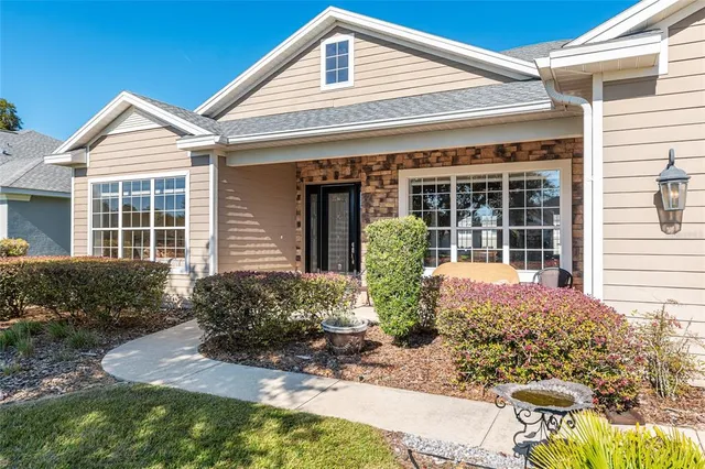 a living room with furniture kitchen view and a window