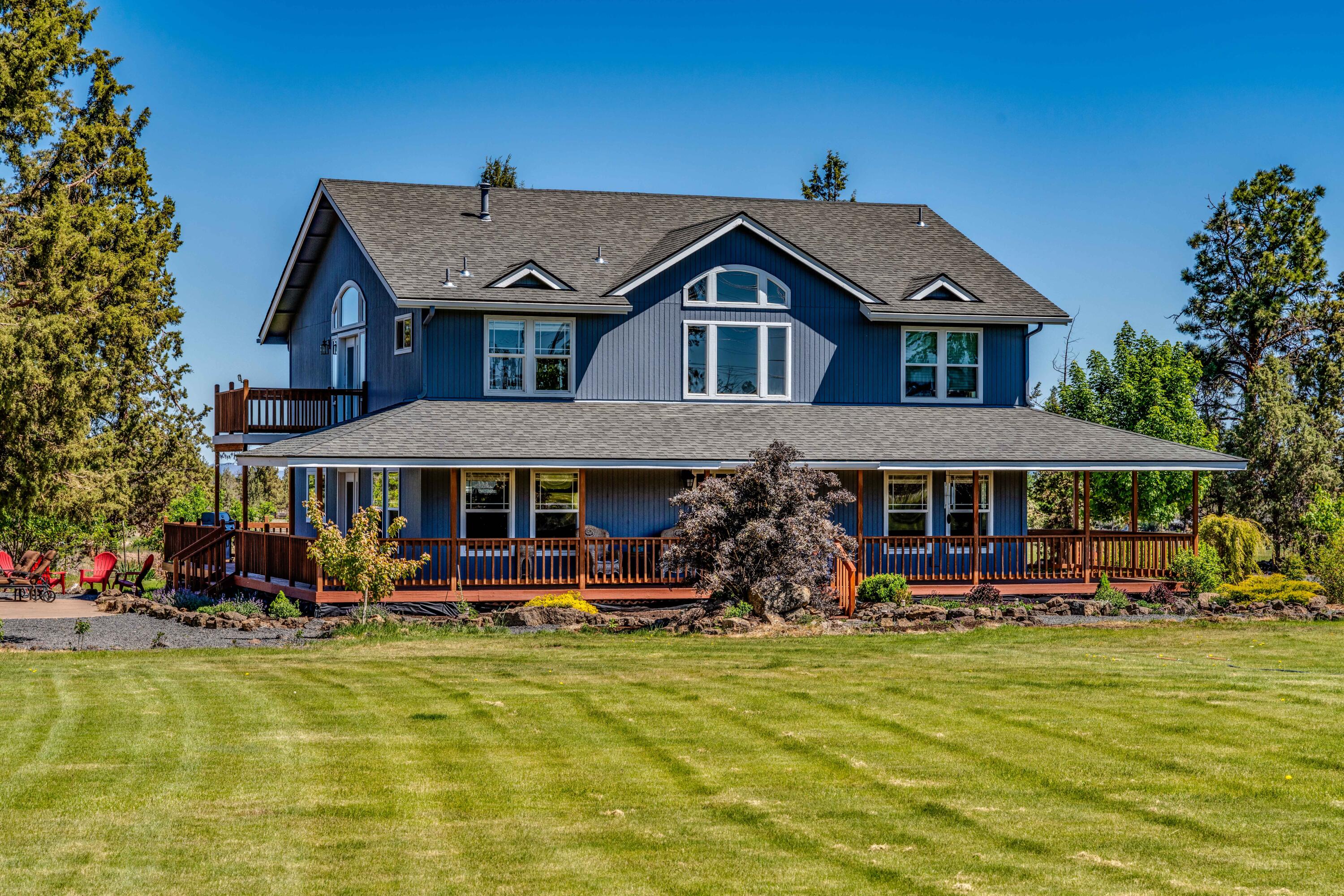 22234 Nelson Road Bend, OR 97701 - Photo 1 of 60 a front view of a building with lots of trees and plants