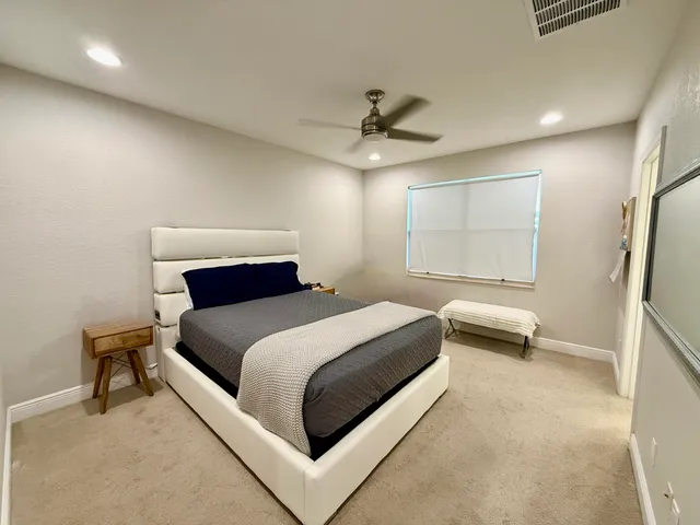 a bedroom with a bed and a chair