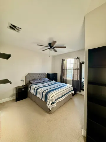 a bathroom with a double vanity sink toilet and a mirror