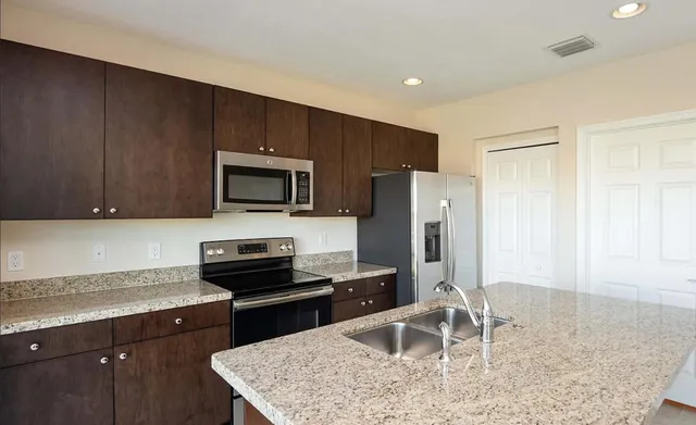 a kitchen with a refrigerator stove and microwave