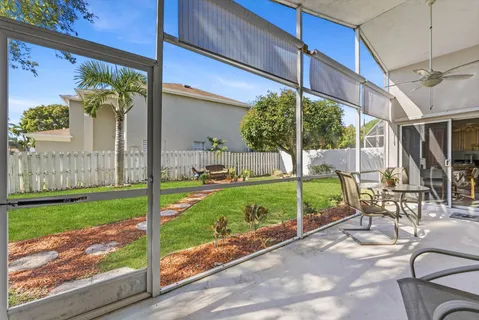 a view of a chair and tables in the patio
