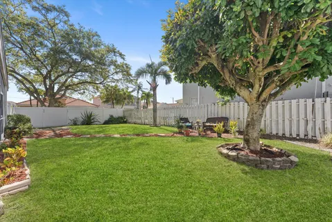 an aerial view of residential houses with outdoor space and lake view
