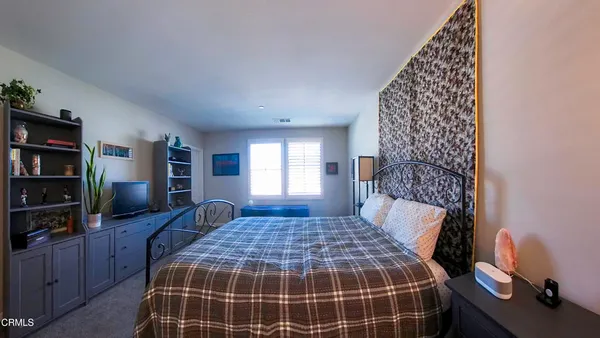 a bedroom with a large bed and a window
