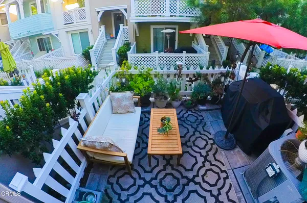 a view of a house with backyard and sitting area