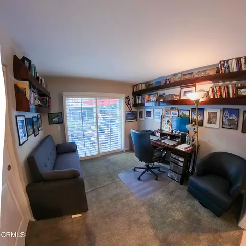 a view of a livingroom with workspace and a couch