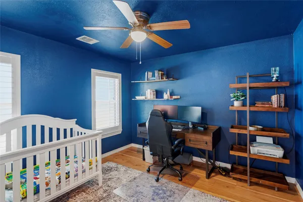 a bedroom with furniture and a book shelf