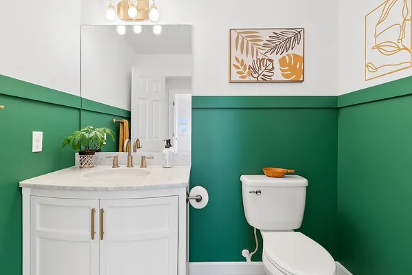 a bathroom with a toilet sink and mirror