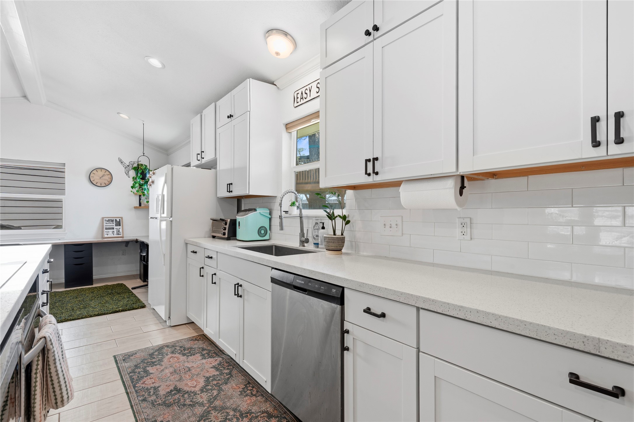 102 Enchanted Oaks Court Spring, TX 77388 - Photo 20 of 48 a kitchen with stainless steel appliances a sink stove and cabinets