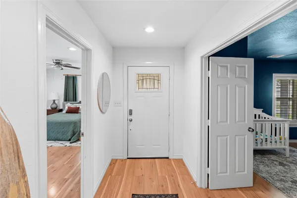 a view of a bedroom with wooden floor