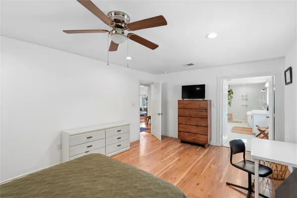 a bedroom with furniture and wooden floor