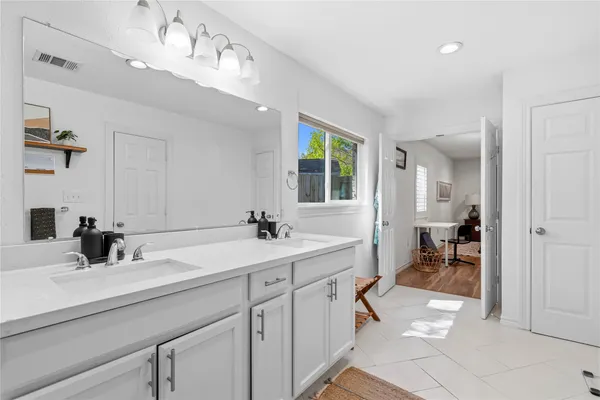 a en suite bathroom with double sink and a mirror
