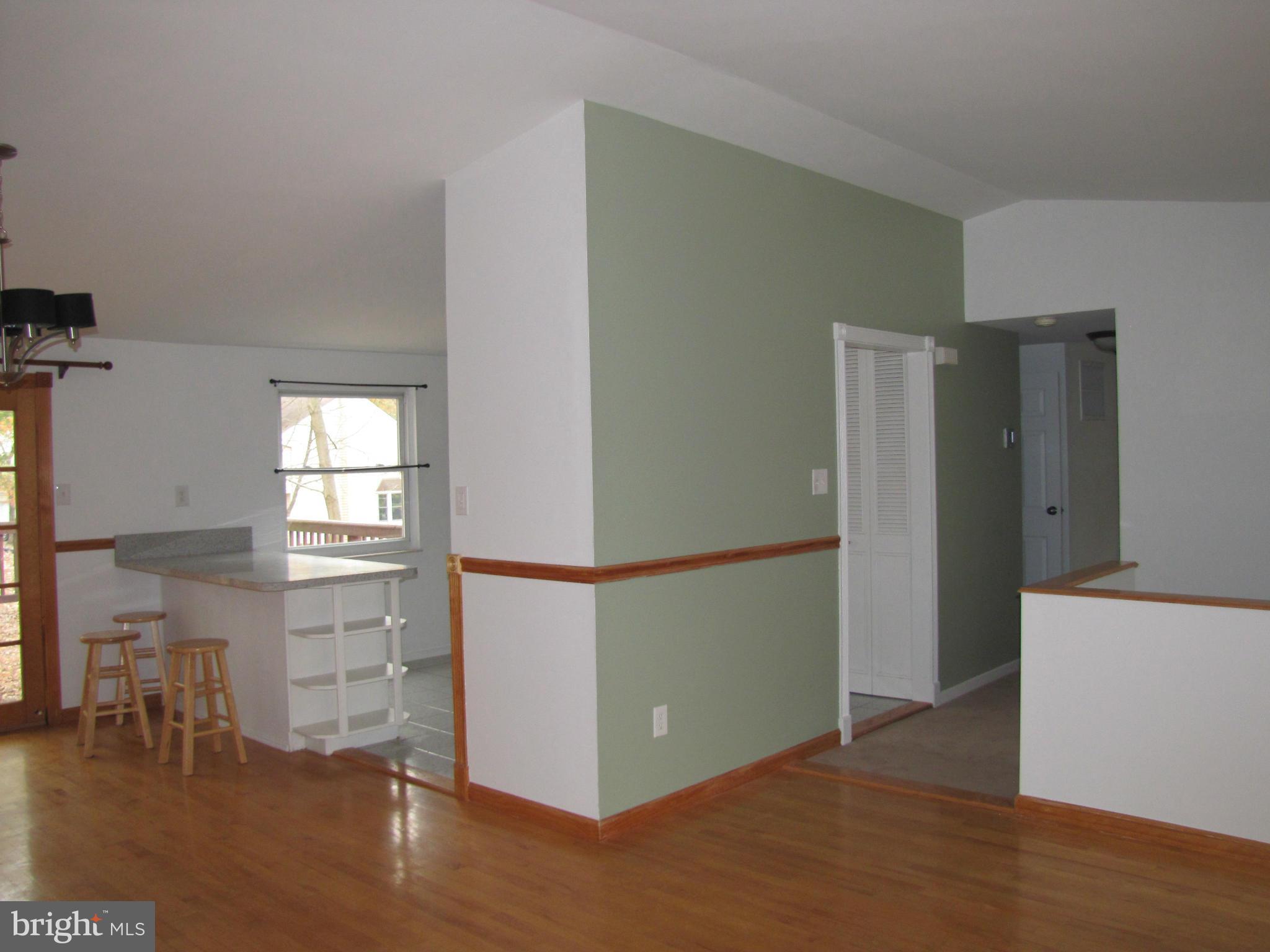 6348 Sandchain Road Columbia, MD 21045 - Photo 11 of 24 a view of a kitchen with a refrigerator cabinets and wooden floor