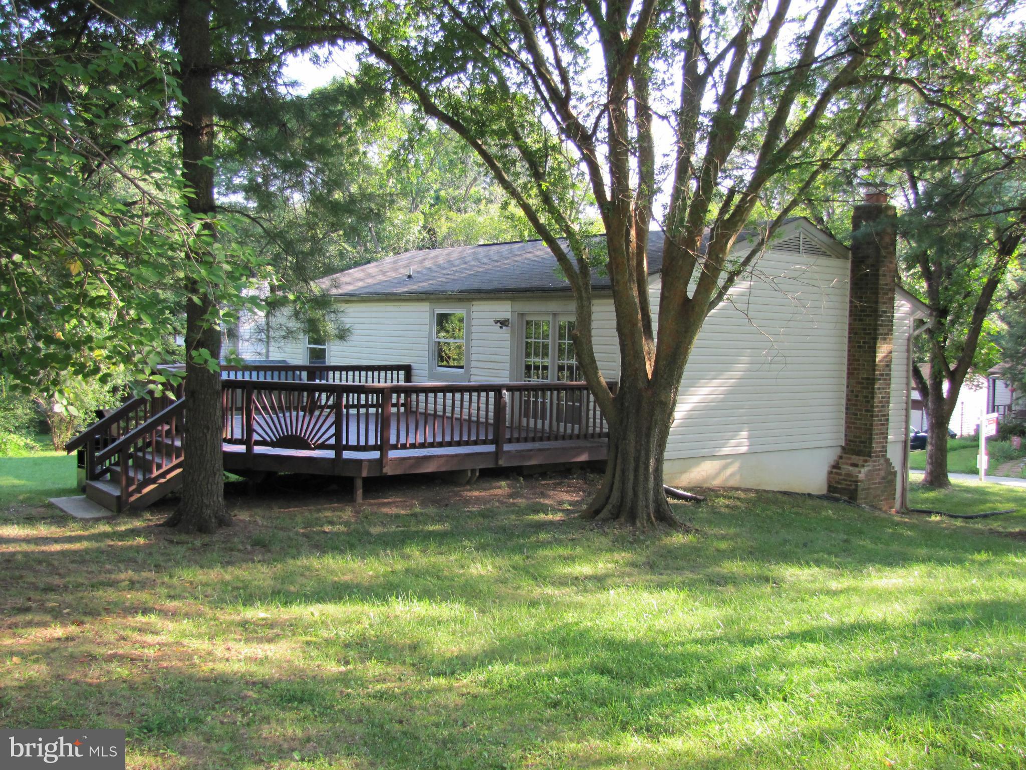 6348 Sandchain Road Columbia, MD 21045 - Photo 3 of 24 a view of a house with a yard deck and a large tree