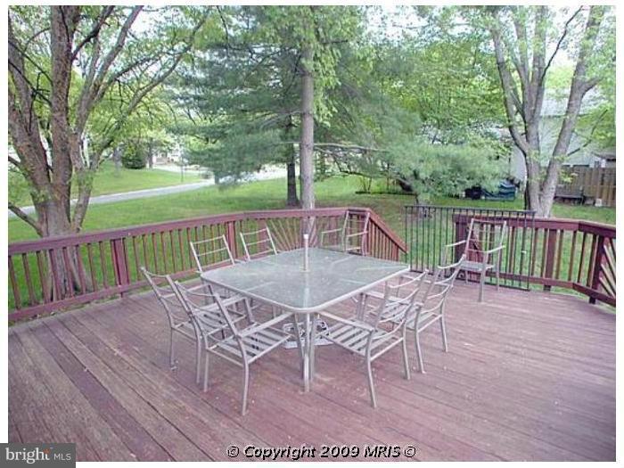 6348 Sandchain Road Columbia, MD 21045 - Photo 4 of 24 a view of a patio with a table chairs and a backyard