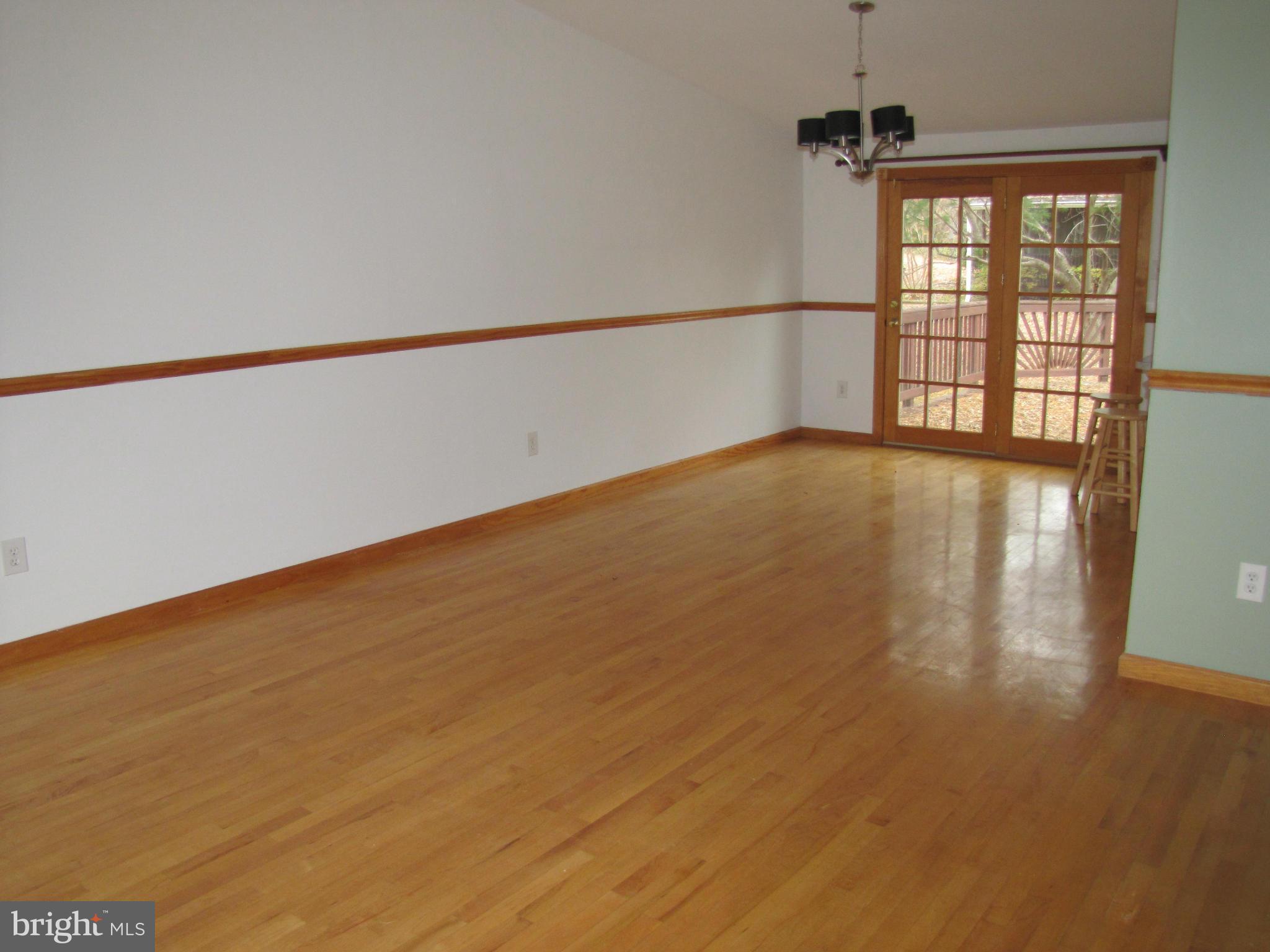 6348 Sandchain Road Columbia, MD 21045 - Photo 9 of 24 a view of an empty room with wooden floor and a window