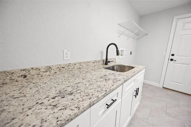 a kitchen with stainless steel appliances granite countertop a stove a microwave and a refrigerator