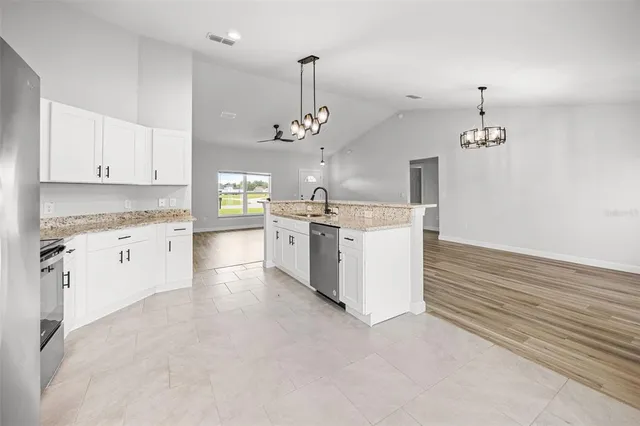 a kitchen that has a lot of cabinets in it
