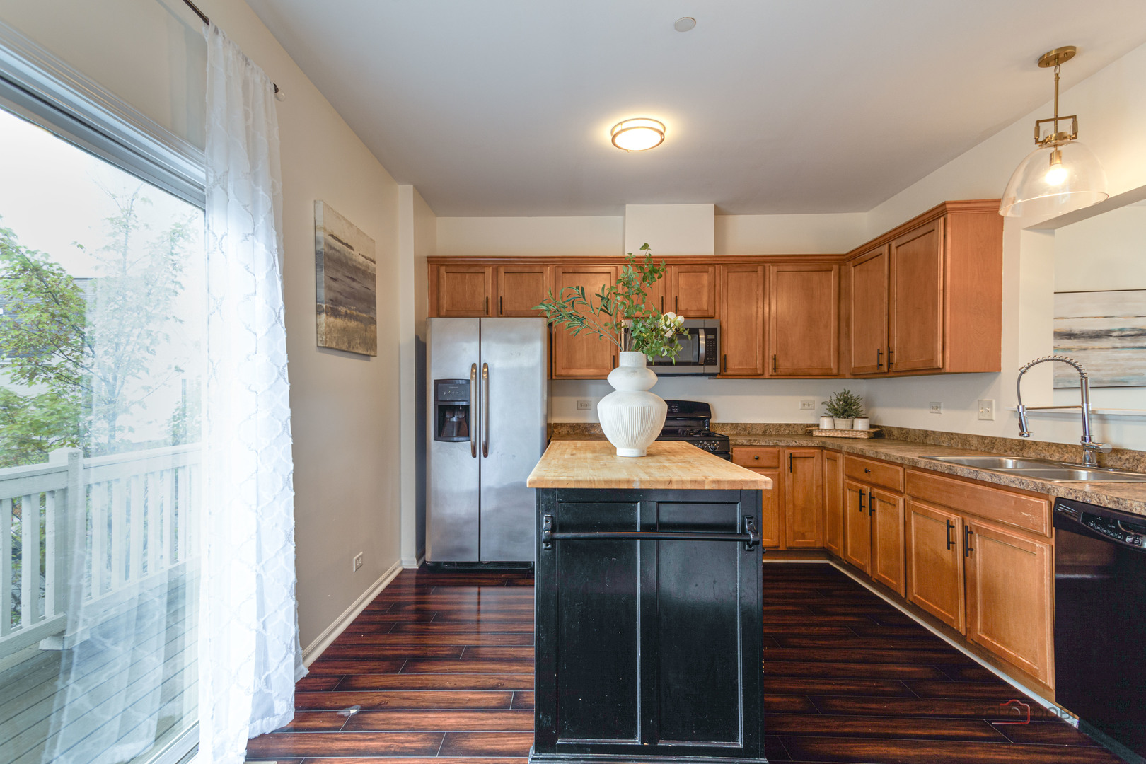 7515e Savoy Lane, Unit C Bridgeview, IL 60455 - Photo 9 of 22 a kitchen with stainless steel appliances granite countertop a refrigerator a sink dishwasher a stove and white countertops with wooden floor
