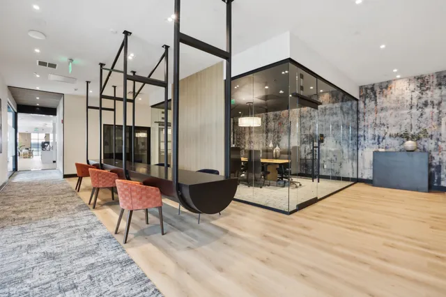a large white kitchen with lots of counter space a sink and stainless steel appliances