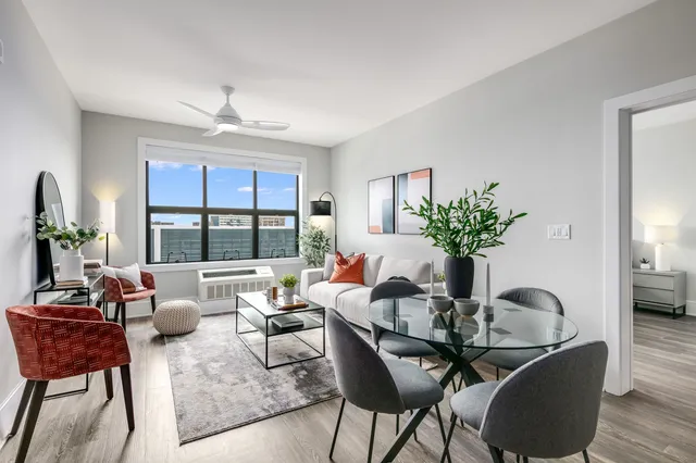 a dining room with furniture a potted plant and a chandelier