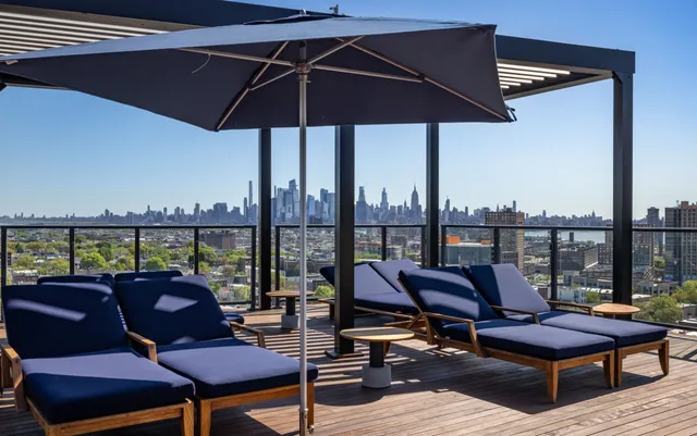 a view of a living room with a floor to ceiling window and wooden floor