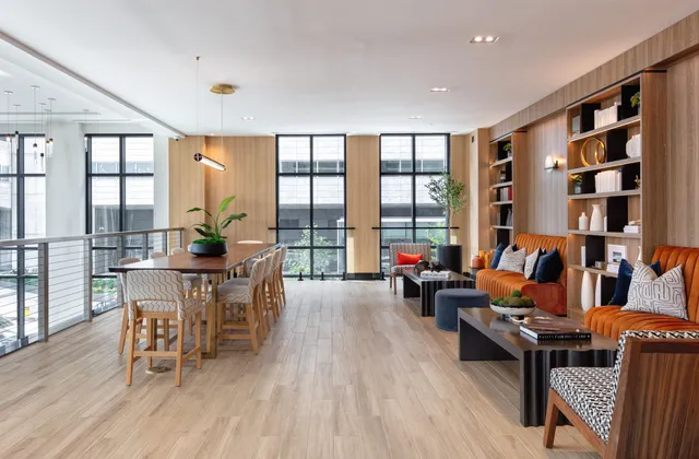 a living room with furniture and floor to ceiling windows
