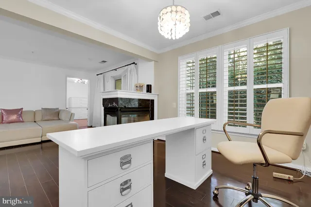 a living room with furniture a fireplace and a large window