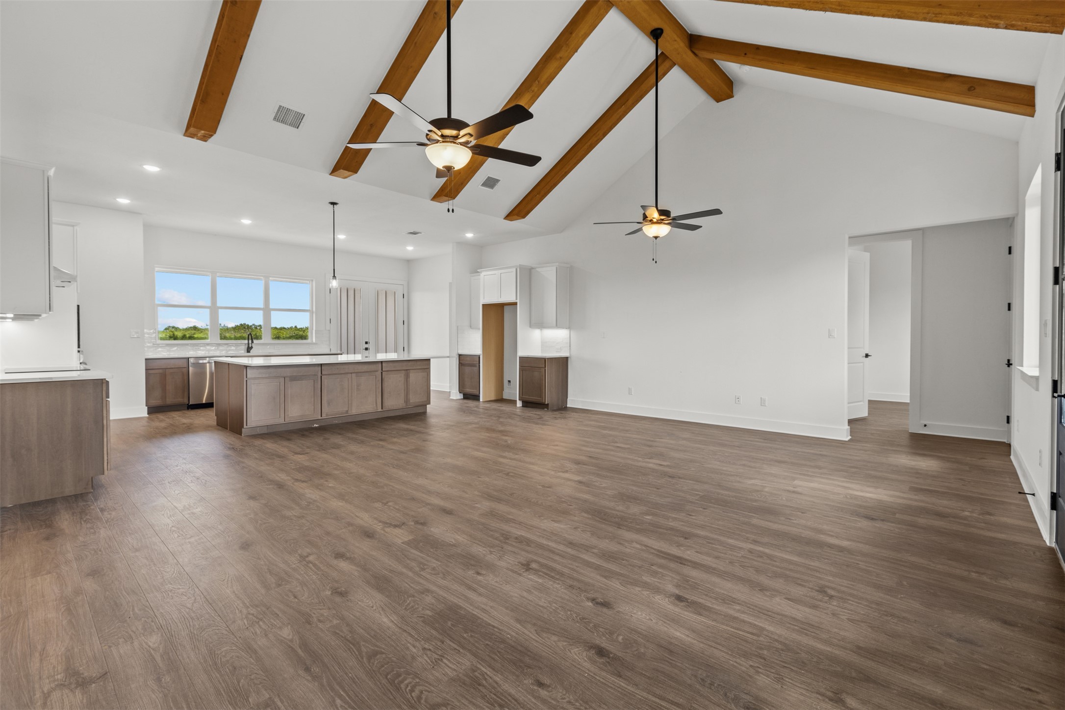 1420 Barth Road Dale, TX 78616 - Photo 32 of 37 Exposed wood beams accentuate soaring vaulted ceilings in this open-concept kitchen and living area.