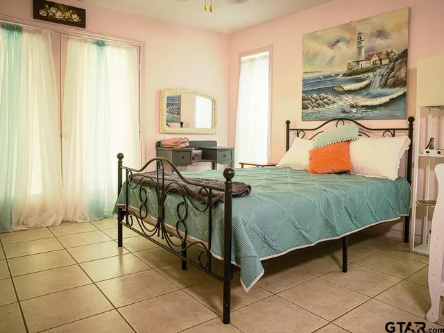 a bedroom with a bed and a window