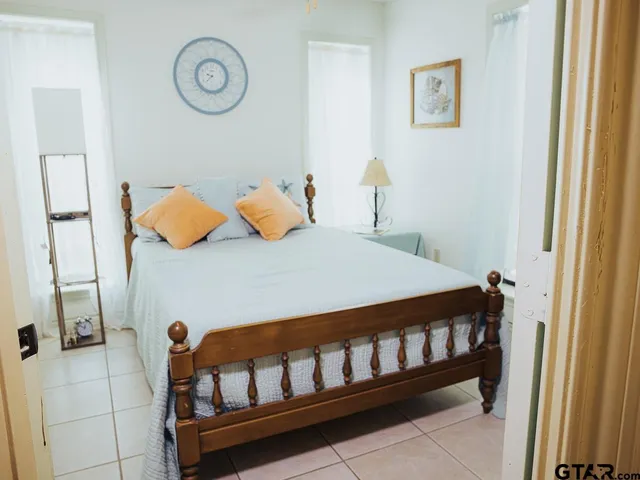 a bedroom with a bed and a window