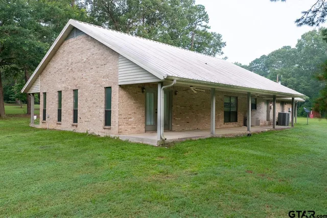 a view of a house with a yard and porch