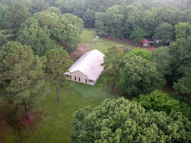 a backyard of a house with a yard and outdoor seating