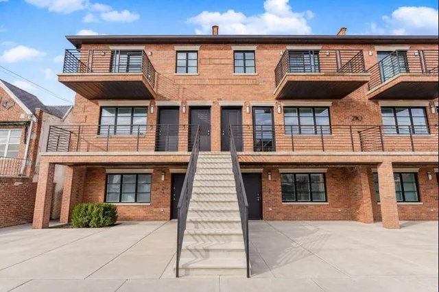 a front view of residential houses with yard