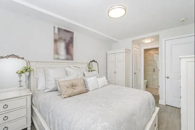 a bedroom with a bed and a painting on the wall