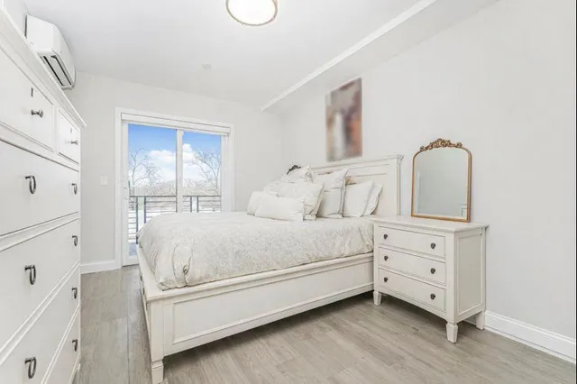 a view of bedroom with furniture and wooden floor