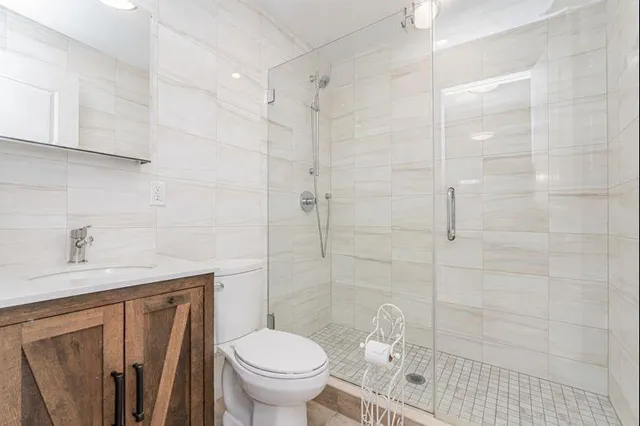 a bathroom with a sink toilet and shower