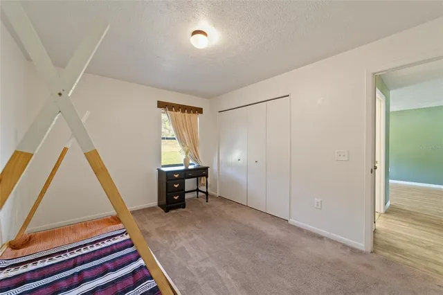 a room with a chair and white walls