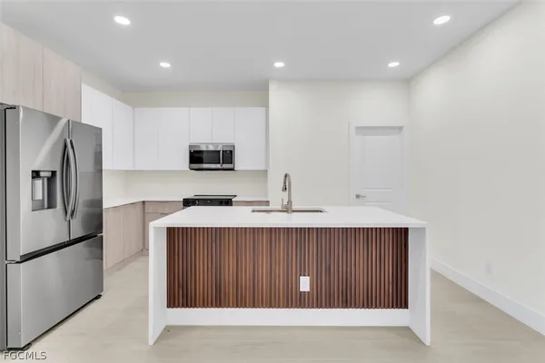 a kitchen with a refrigerator and a sink