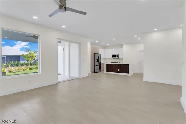 an empty room with a fireplace and outdoor view