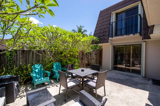 a view of a patio with table and chairs and potted plants