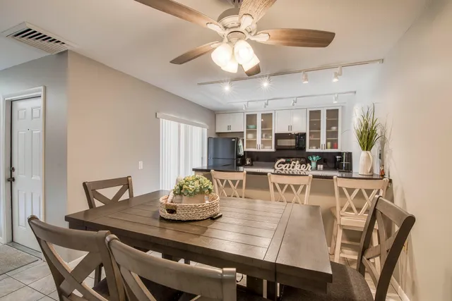 a view of a dining room with furniture and a chandelier