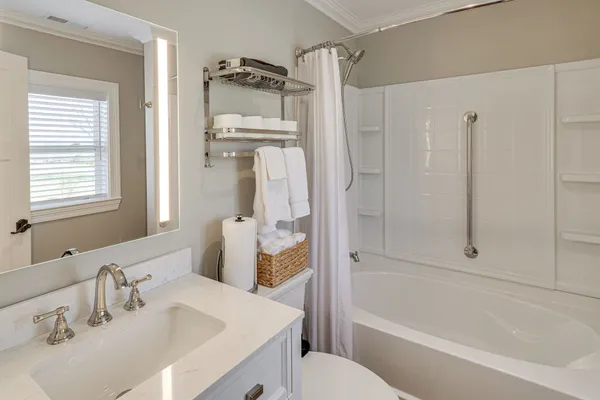 a bathroom with a sink toilet and shower