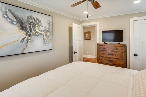 a bedroom with a bed and a flat screen tv