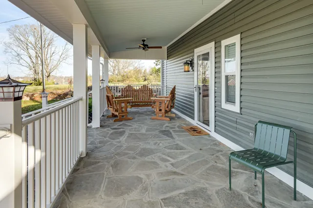 a balcony with chairs and wooden fence