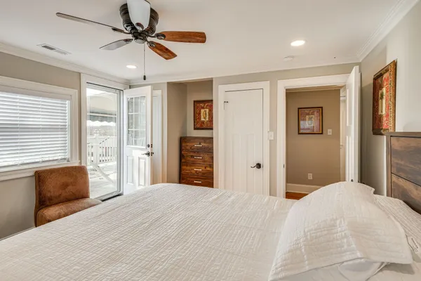 a bedroom with a large bed dresser and a window