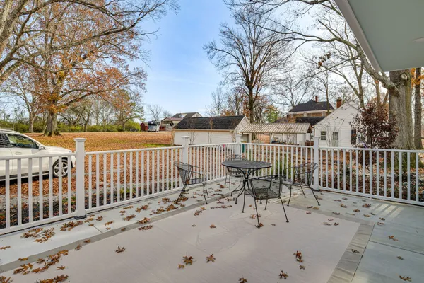 a view of a chair and tables on the deck